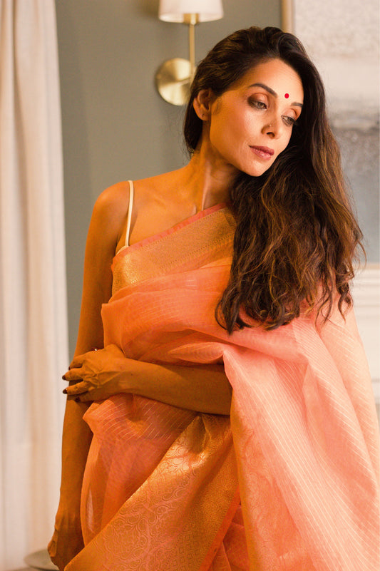 Rust Pink Pure Banarasi Organza Saree With Woven Gold Pin Stripes and a Wide Jari border.