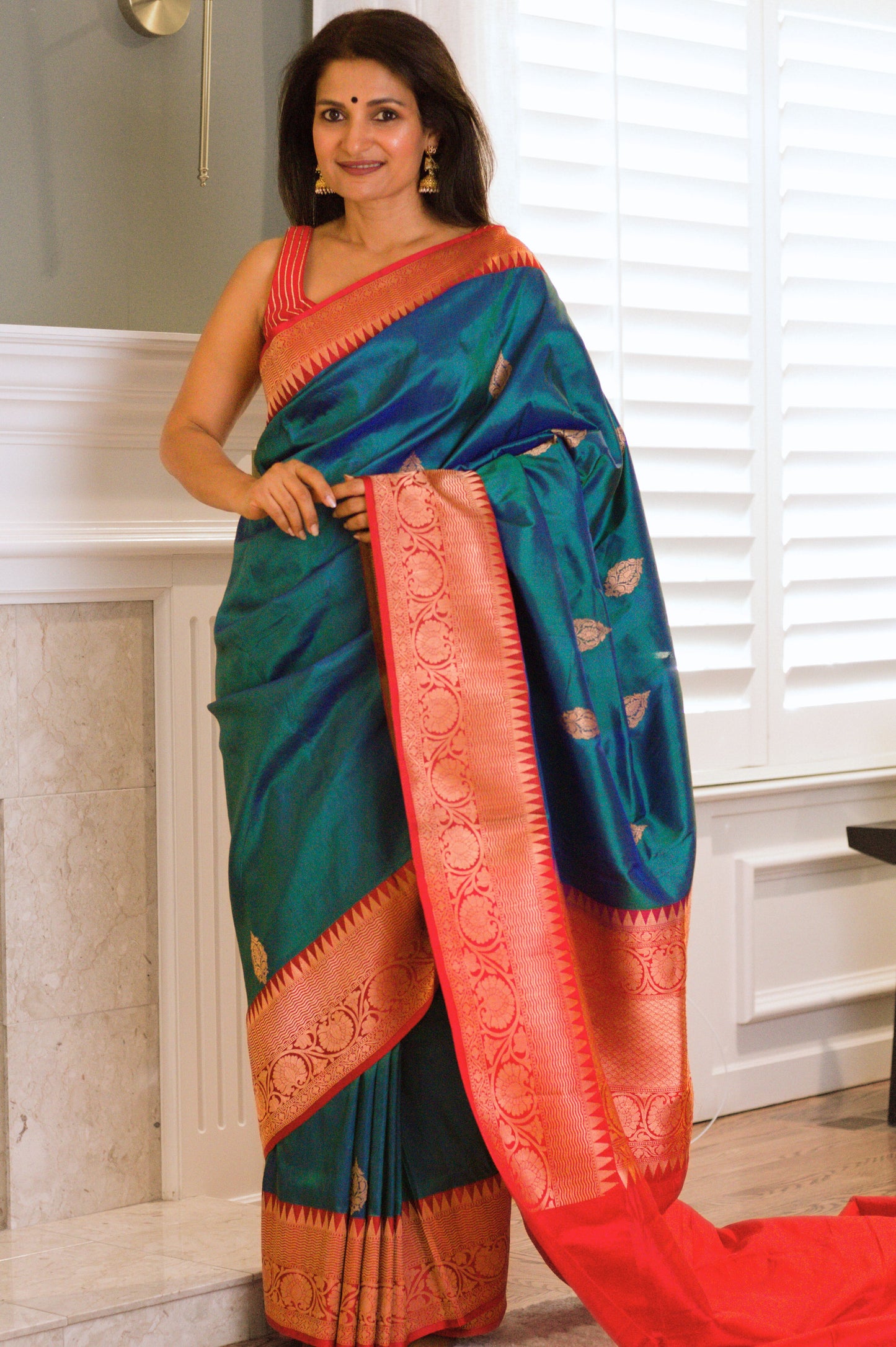 Iridescent Peacock Blue Banarasi Pure Katan Silk Saree With Red Border and Subtle Gold Jari