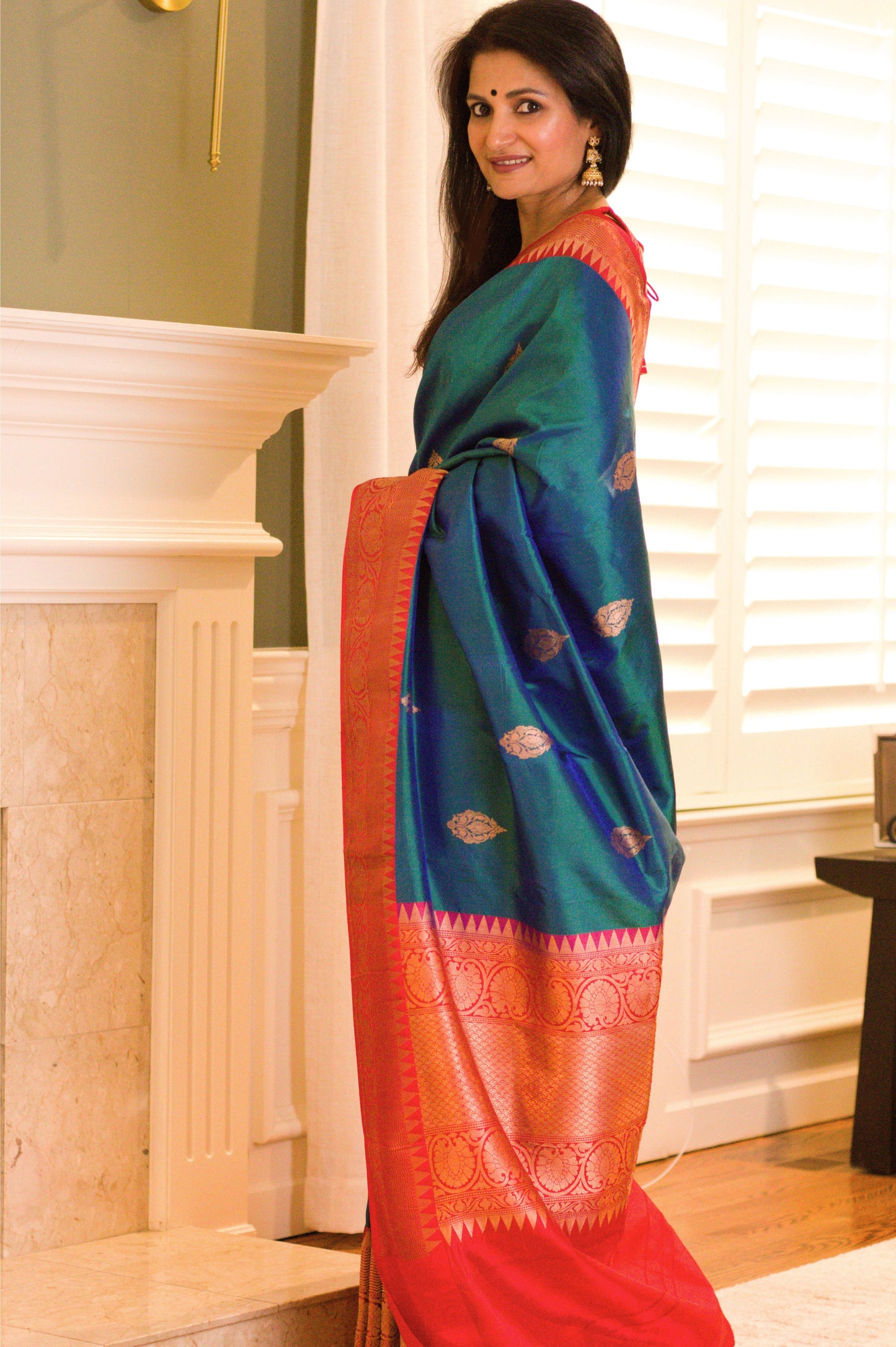 Iridescent Peacock Blue Banarasi Pure Katan Silk Saree With Red Border and Subtle Gold Jari