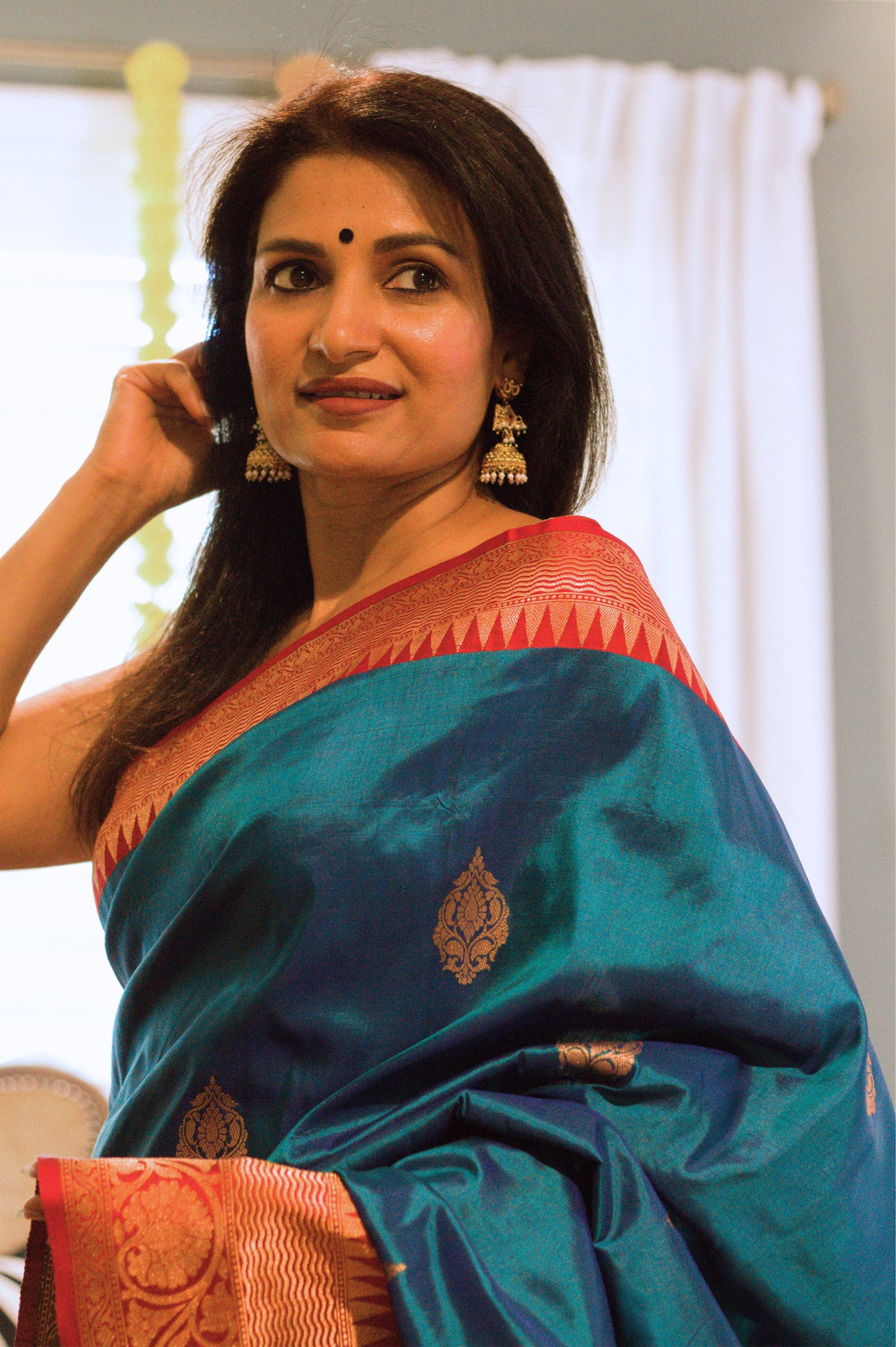 Iridescent Peacock Blue Banarasi Pure Katan Silk Saree With Red Border and Subtle Gold Jari